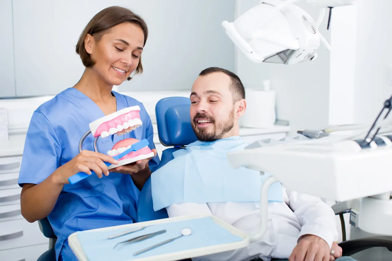 A Molina Endodontics team member reviewing tooth anatomy with a patient in the treatment chair