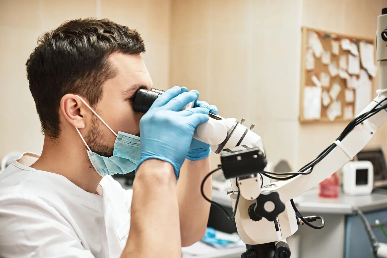 Endodontist using a surgical microscope for precise endodontic care at Molina Endodontics